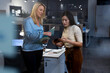 © Wavebreak Media - Multiracial female professional discussing over digital tablet while working late in modern office