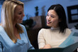 © Wavebreak Media - Happy multiracial female coworkers looking at each other while analyzing financial report in office