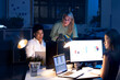 © Wavebreak Media - Multiracial professionals working and discussing over computers in modern office late at night