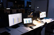 © Wavebreak Media - Computers with laptops, illuminated pendant lights, smartphone and diaries on desk in modern office