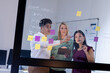 © Wavebreak Media - Multiracial coworkers brainstorming over data and adhesive notes on glass wall in office at night
