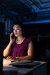 © Wavebreak Media - Asian serious businesswoman talking over mobile phone and working over computer at desk in office