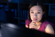© Wavebreak Media - Thoughtful asian female professional with hand on chin looking at computer screen in office at night