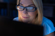 © Wavebreak Media - Close-up of caucasian businesswoman wearing eyeglasses working over computer in office at night
