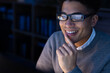 © Wavebreak Media - Close-up of smiling asian male professional wearing eyeglasses with finger on chin using computer