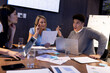 © Wavebreak Media - Multiracial professionals with reports and laptops analyzing sales data and brainstorming in meeting