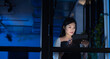 © Wavebreak Media - Asian businesswoman using digital tablet while standing by window in office at night seen over glass