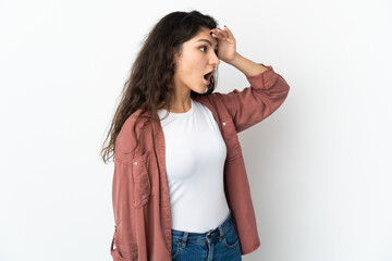 Wall Mural - Teenager Russian girl isolated on white background with surprise expression while looking side