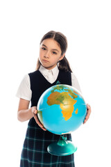 Canvas Print - Serious schoolchild holding globe and looking at camera isolated on white.