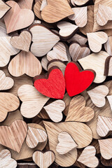 Wall Mural - Wooden hearts, one red heart on the heart background.