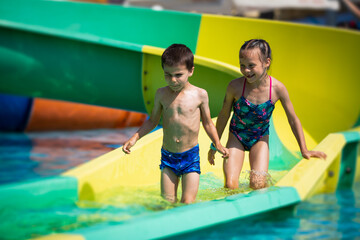 Two little kids having fun in aquapark