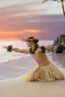 Male Hula Dancer on the beach with a sunset sky of fire in the background 