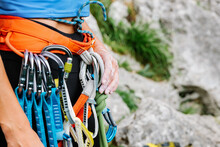 Faceless Mountaineer Holding Climbing Equipment In Forest