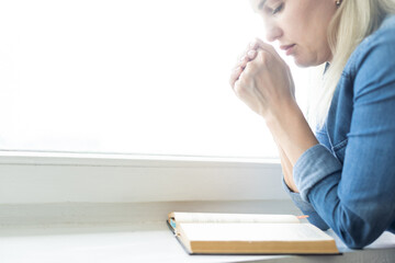 Wall Mural - Christian life crisis prayer to god. Woman Pray for god blessing to wishing have a better life. woman hands praying to god with the bible. begging for forgiveness and believe in goodness