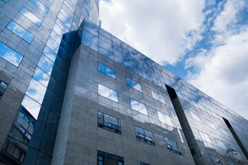 Wall Mural - Building facade with blue sky and white clouds