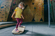 Little girl preschooler training on fitness balance board