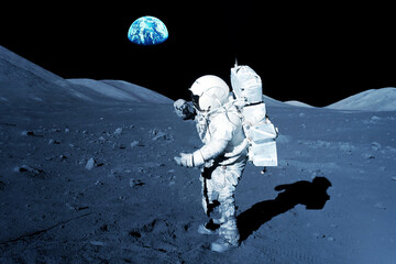 Wall Mural - astronaut on the moon, with the earth in the background. elements of this image furnished by nasa