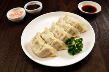 Wall Mural - Freshly baked dumplings with plenty of gravy on the table