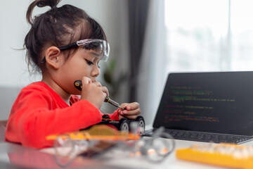 Asia students learn at home in coding robot cars and electronic board cables in STEM, STEAM, mathematics engineering science technology computer code in robotics for kids concept.