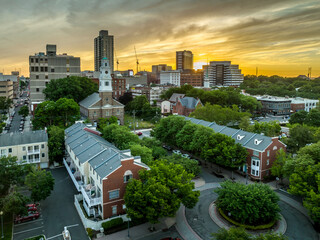 Wall Mural - Aerial view of downtown New Brunswick, New Jersey with dramatic colorful sunset sky low rise apartment buildings and first reformed church, high rise office buildings, parking lots