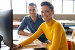 © Wavebreak Media - Portrait of smiling multiracial colleagues sitting at desk in creative office