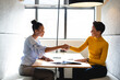 © Wavebreak Media - Multiracial businesswomen handshaking during meeting in creative office