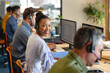 © Wavebreak Media - Portrait of smiling african american female customer service executive with colleagues in office