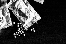 Packets Of Desiccant Scattered On A Dark Surface