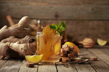 Ginger tea with ingredients on an old wooden table.