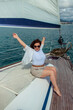 © Daria - woman tourist traveler in sunglasses on a summer day on a yacht in the sea