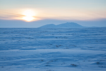 Wall Mural - winter arctic landscape. view of the snow-covered tundra and snow-capped mountains. cold frosty wint