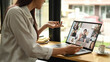 © Prathankarnpap - Cropped shot young business woman having online video call on laptop while sitting in modern workplace