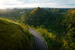 A happy young woman enjoys a panoramic view drone at sunset in the Chocolate Hills of Bohol, Philippines