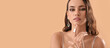 © Pixel-Shot - Beautiful young woman wearing stylish jewelry on beige background with space for text