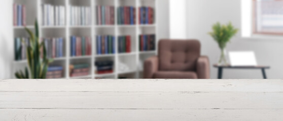 Bookcase with armchair in modern interior of room