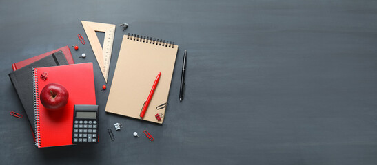 School stationery and apple on chalkboard with space for text