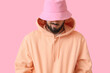 © Pixel-Shot - Fashionable bearded man on pink background