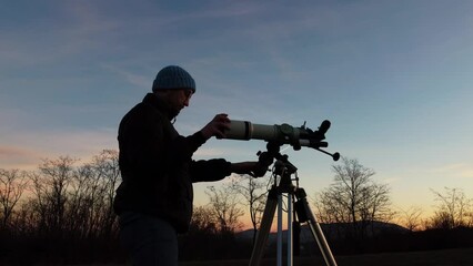 Wall Mural - silhouette of a man and telescope under the night sky.