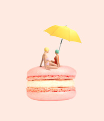 Wall Mural - Contemporary art collage. Two girls in swimming suit sitting on delicious dessert, macaron under beach umbrella