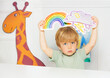 Boy in the class show weather cards with rain and rainbow