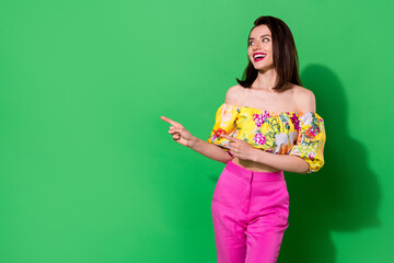 Wall Mural - photo of cheerful adorable person look direct fingers empty space isolated on green color background