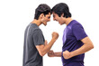 © IndiaPix - Portrait of two teenage boys fighting against pain background