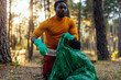 African American man collecting garbage outdoors