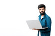 © PRASANNAPIX - Young indian man using laptop on white background.