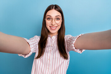 Poster - Self portrait of attractive cheerful brown haired girl good mood isolated over vivid blue color background