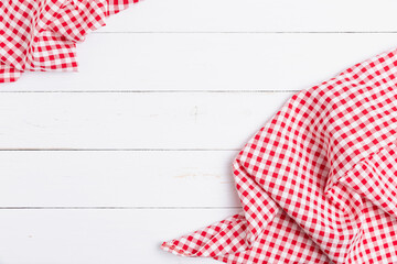 Backdrop for menu of food to restaurants. Red and white fabric tablecloth checkered on wooden white background with copy space. top view, flat lay.