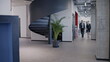 © Synthex - Successful business people walking along hall of corporate building to meet partners
