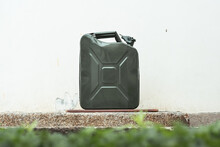 Green Jerrycan On White Background. Gas Canister Full Of Gasoline. Fuel Shortage While Travelling Far