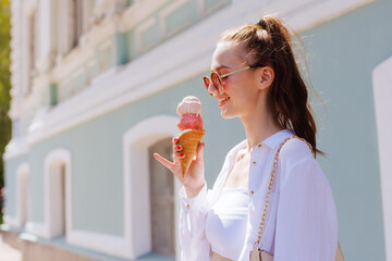 girl enjoying ice cream in a cone with ice cream balls