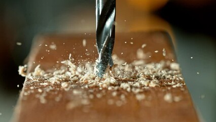 Wall Mural - Super slow motion of detail of a drill bit drilling into wood. Filmed on high speed cinema camera, 1000 fps.